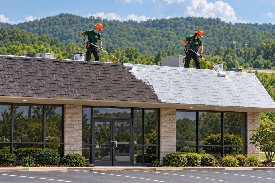 Crew coating a commercial asphalt shingle roof
